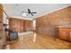 Open living room featuring brick accent wall, hardwood floors, and charming wood-burning stove at 305 Plantation Dr, Kings Mountain, NC 28086