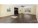 Inviting living room featuring wood flooring and natural light streaming through expansive windows at 305 Plantation Dr, Kings Mountain, NC 28086