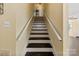 Classic staircase with contrasting black steps and white risers, leading to the upper level at 305 Plantation Dr, Kings Mountain, NC 28086