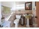Tiled bathroom with pedestal sink, toilet, and window at 3099 Trinity Church Rd, Concord, NC 28027