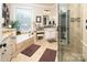 Bright bathroom with double sink vanity, makeup table, soaking tub, and glass enclosed shower at 3099 Trinity Church Rd, Concord, NC 28027