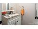 Charming powder room with granite countertop, white cabinets, and decorative fixtures at 3099 Trinity Church Rd, Concord, NC 28027