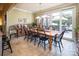 Traditional dining room features a long wooden table with black chairs and sliding glass doors to an outdoor patio at 3099 Trinity Church Rd, Concord, NC 28027