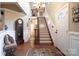 Elegant foyer with hardwood floors, a grand staircase, decorative rug and beautiful chandelier at 3099 Trinity Church Rd, Concord, NC 28027