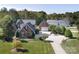 Expansive brick home with a lush lawn, oversized driveway, detached garage and additional parking space at 3099 Trinity Church Rd, Concord, NC 28027