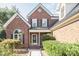 Beautiful front exterior showcasing brick details, black shutters and a well-manicured lawn at 3099 Trinity Church Rd, Concord, NC 28027