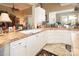 Corner kitchen view highlighting white cabinets, tile countertops, and natural lighting at 3099 Trinity Church Rd, Concord, NC 28027