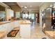 Open kitchen concept showcases tile countertops, center island, and seamless flow to dining area at 3099 Trinity Church Rd, Concord, NC 28027