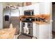 Contemporary kitchen design with stainless steel appliances, custom cabinetry, and unique tile backsplash at 3099 Trinity Church Rd, Concord, NC 28027