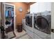 Functional laundry room with modern washer and dryer, built-in shelving, and access to walk-in closet at 3099 Trinity Church Rd, Concord, NC 28027