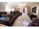 Inviting living room with plush brown reclining sofas, a ceiling fan, and a large television for entertainment at 3099 Trinity Church Rd, Concord, NC 28027