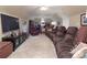 Spacious living room featuring a large reclining sofa, TV, and additional seating, perfect for relaxation and entertainment at 3099 Trinity Church Rd, Concord, NC 28027