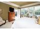 Bright main bedroom with large windows overlooking the backyard and an open patio door at 3099 Trinity Church Rd, Concord, NC 28027