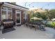 Outdoor patio featuring a dining set with an umbrella and a grill, ideal for outdoor cooking and entertaining at 3099 Trinity Church Rd, Concord, NC 28027
