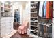 Well organized walk-in closet featuring custom shelving and multiple storage options at 3099 Trinity Church Rd, Concord, NC 28027