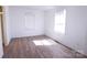 Bright bedroom features new flooring and ample natural light through white-trimmed windows at 313 Nassau Pl, Gastonia, NC 28052
