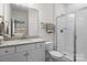 Clean bathroom boasts a granite countertop, white vanity, and glass shower enclosure at 3212 Burnello Ct, Iron Station, NC 28080