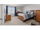 Bedroom features a plush carpet, window, ceiling fan, and dark wood furniture at 3212 Burnello Ct, Iron Station, NC 28080