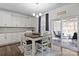 Bright dining area features modern chandelier, breakfast bar and slider to screened porch at 3212 Burnello Ct, Iron Station, NC 28080