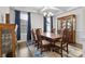 Formal dining room with hardwood floors, blue rug, chandelier, and wood table with seating for six at 3212 Burnello Ct, Iron Station, NC 28080