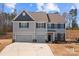 Two-story home with a two-car garage and neutral color palette offers curb appeal at 3212 Burnello Ct, Iron Station, NC 28080