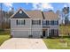 Charming two-story home with a two-car garage, manicured lawn, and classic architectural details at 3212 Burnello Ct, Iron Station, NC 28080
