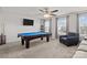 Spacious game room features a pool table, comfortable seating, and a mounted TV, perfect for entertaining guests and Gathering at 3212 Burnello Ct, Iron Station, NC 28080