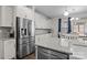 Modern kitchen showcasing stainless steel refrigerator, granite countertops, and white cabinetry at 3212 Burnello Ct, Iron Station, NC 28080