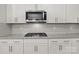 Updated kitchen with a stainless steel microwave, gas range, and white cabinets at 3212 Burnello Ct, Iron Station, NC 28080