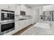 Bright kitchen featuring stainless steel appliances, granite counters, and white cabinetry at 3212 Burnello Ct, Iron Station, NC 28080