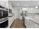 Modern kitchen features white cabinets, stainless steel appliances, and granite countertops at 3212 Burnello Ct, Iron Station, NC 28080