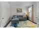 Comfortable living room with a sectional couch, accent rug, and plenty of light at 3212 Burnello Ct, Iron Station, NC 28080