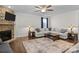 Inviting living room featuring a stone fireplace, large sectional sofa, and neutral color palette at 3212 Burnello Ct, Iron Station, NC 28080