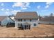 Rear exterior showcasing a well-maintained yard, screened in porch and patio, perfect for outdoor enjoyment and entertainment at 3212 Burnello Ct, Iron Station, NC 28080