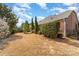 Lush backyard featuring a well-maintained lawn, privacy landscaping, and a charming brick home exterior at 333 Willow Brook Dr, Matthews, NC 28105