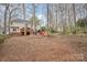 Expansive backyard features a wooden deck and a stone fire pit with seating for entertaining at 3400 Thistle Bloom Ct, Charlotte, NC 28269