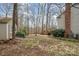 Spacious backyard with a lush lawn, mature trees, and a charming gazebo deck for outdoor enjoyment at 3400 Thistle Bloom Ct, Charlotte, NC 28269