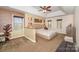 Spacious primary bedroom featuring a tray ceiling, carpeted floors, and lots of natural light with a neutral color scheme at 3400 Thistle Bloom Ct, Charlotte, NC 28269