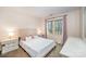 A bedroom with a light color scheme and matching bedside tables, with lots of natural light streaming in at 3400 Thistle Bloom Ct, Charlotte, NC 28269