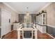 Formal dining room featuring stylish wallpaper, hardwood floors, and an elegant chandelier at 3400 Thistle Bloom Ct, Charlotte, NC 28269