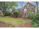 Traditional brick home boasts lush landscaping, an American flag, and a warm, inviting facade at 3400 Thistle Bloom Ct, Charlotte, NC 28269