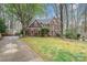 Attractive brick home showcases mature trees, a well-kept lawn, and a long driveway at 3400 Thistle Bloom Ct, Charlotte, NC 28269
