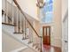 Bright foyer featuring a staircase, hardwood floors, and a large arched window above the front door at 3400 Thistle Bloom Ct, Charlotte, NC 28269