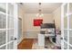 Bright home office with hardwood floors, white wainscoting, large monitor, and abstract art at 3400 Thistle Bloom Ct, Charlotte, NC 28269