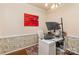 Well-lit home office with white desk, large monitor, area rug, and decor at 3400 Thistle Bloom Ct, Charlotte, NC 28269