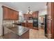 Kitchen featuring dark wood cabinets, tile backsplash, and stainless-steel appliances at 3400 Thistle Bloom Ct, Charlotte, NC 28269