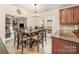 Eat-in kitchen with granite countertops, tile backsplash, and a rustic wooden dining set at 3400 Thistle Bloom Ct, Charlotte, NC 28269