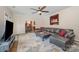 Spacious living room with a ceiling fan, a large sectional couch, and abstract art at 3400 Thistle Bloom Ct, Charlotte, NC 28269