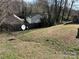Overgrown backyard with a satellite dish at 3813 Brookchase Ln, Charlotte, NC 28205