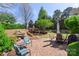 Backyard patio with stone pavers, outdoor furniture, and lush landscaping at 4001 Perth Rd, Fort Mill, SC 29707